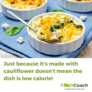 high calorie casserole dish made with cauliflower and lots of cheese in fancy serving dish