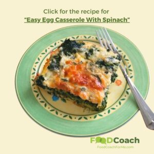 a slice of an healthy breakfast egg casserole with spinach and toasted cheese on a yellow plate with a pale green border